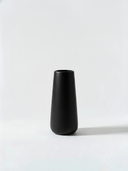 Minimalist black ceramic vase on a white background