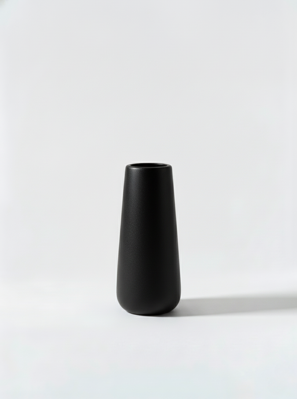 Minimalist black ceramic vase on a white background