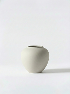 Minimalist white ceramic vase on a white background