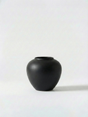 Minimalist black ceramic vase on a white background