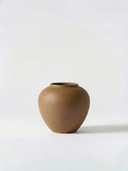Minimalist brown ceramic vase on a white background