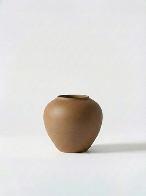 Minimalist brown ceramic vase on a white background