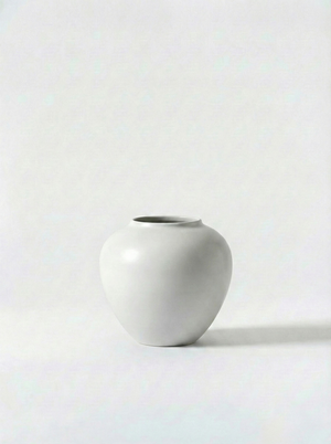 Minimalist gloss white ceramic vase on a white background