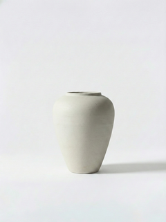 Minimalist white ceramic vase on a white background