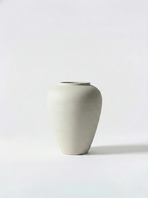 Minimalist white ceramic vase on a white background