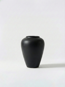 Minimalist black ceramic vase on a white background