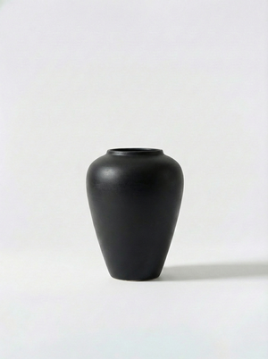 Minimalist black ceramic vase on a white background