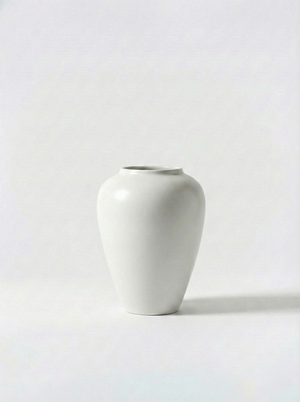 Minimalist white ceramic vase on a white background
