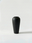Minimalist black ceramic vase on a white background