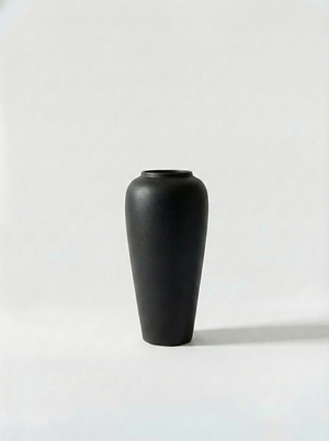 Minimalist black ceramic vase on a white background
