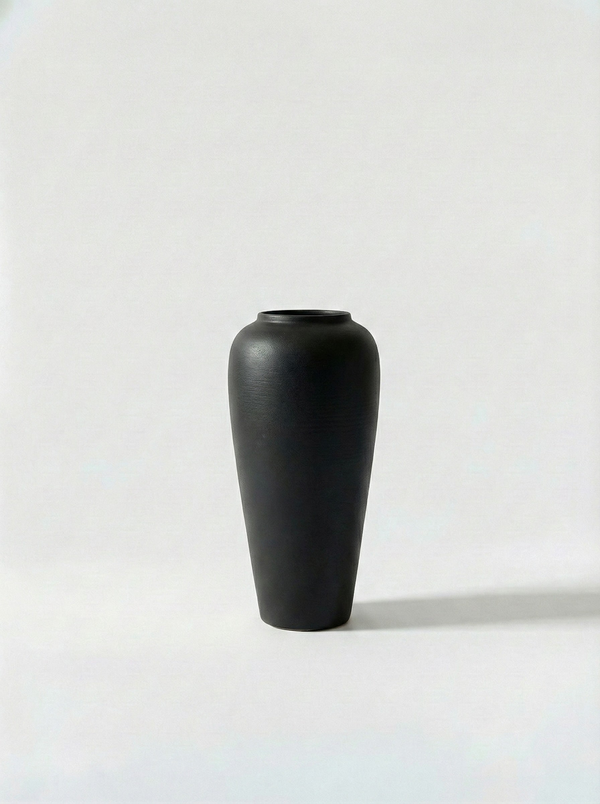 Minimalist black ceramic vase on a white background
