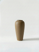 Minimalist beige ceramic vase on a white background