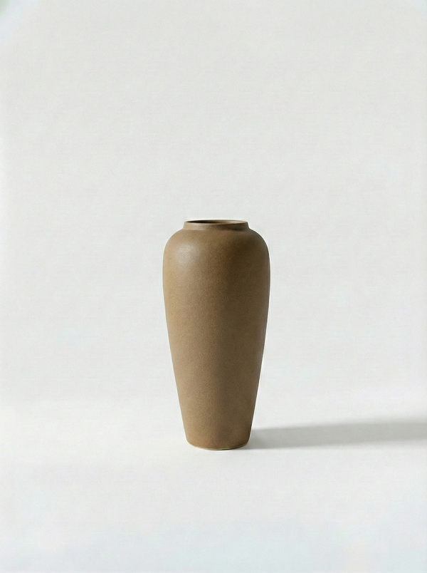 Minimalist beige ceramic vase on a white background