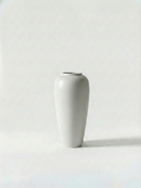 Minimalist gloss white ceramic vase on a white background