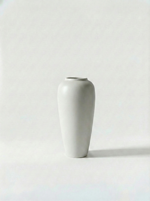 Minimalist gloss white ceramic vase on a white background