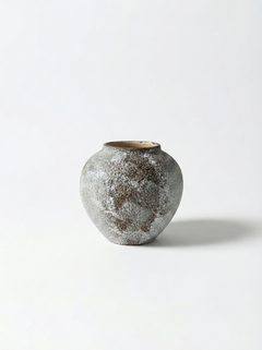 Textured ceramic vase on a white background