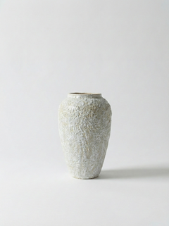Textured ceramic vase on a light gray background