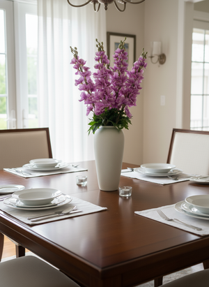 Elegant dining table styled with a pink faux delphinium arrangement in a white ceramic vase #lavender-pink
