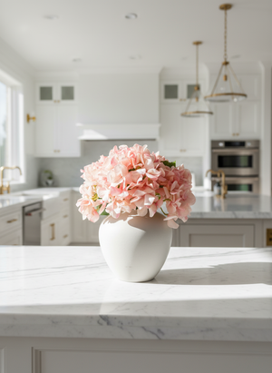 Elegant peachy pink artificial hydrangea arrangement on marble kitchen bench top #peachy-pink