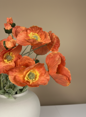 Close-up of vibrant luxury real touch faux orange poppy flowers with realistic centres in a white ceramic vase #orange