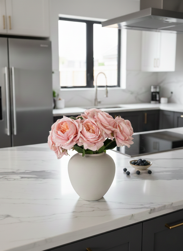 Artificial pink rose arrangement in a matte ceramic vase styled on a marble kitchen island in a modern white kitchen  #pink