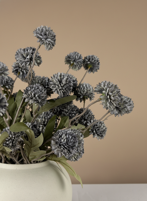 Close up of grey real touch faux pompom flowers with delicate textured blooms arranged in a ceramic vase #grey