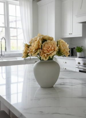Luxury yellow artificial peonies styled in ceramic vase on modern kitchen bench top #yellow