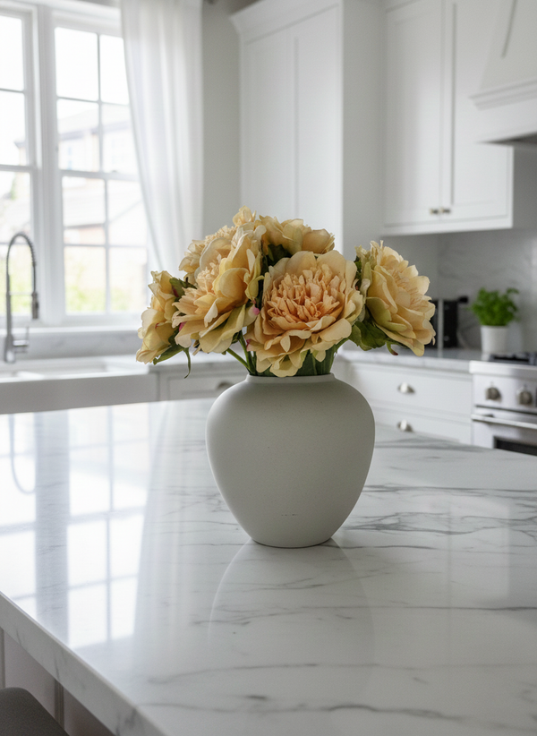 Luxury yellow artificial peonies styled in ceramic vase on modern kitchen bench top #yellow