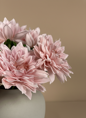 Detailed close-up of artificial pink dahlia blooms with layered petals in a ceramic vase #pink