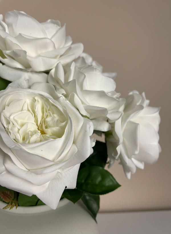 Lifelike faux white rose blooms with layered petals styled in a minimalist ceramic vase #white