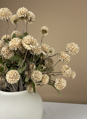 Close up of beige real touch faux pompom flowers with delicate textured blooms arranged in a ceramic vase #beige
