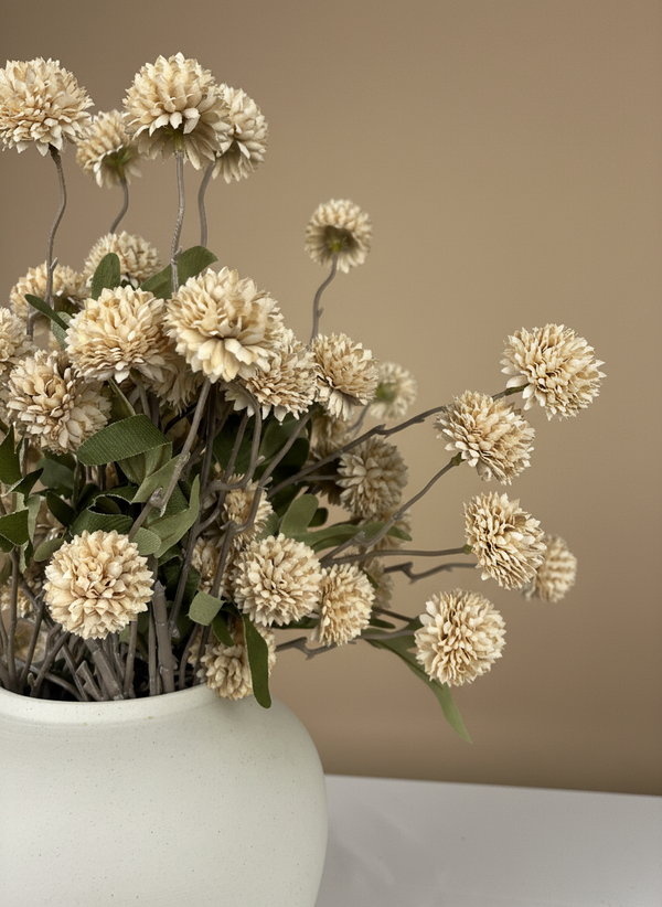 Close up of beige real touch faux pompom flowers with delicate textured blooms arranged in a ceramic vase #beige