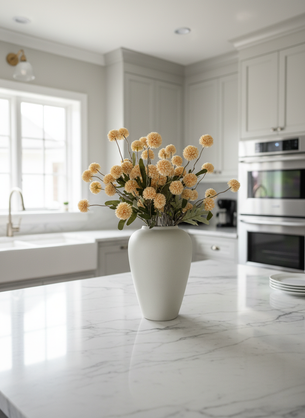 Pale peach coloured real touch faux pompom flowers styled in a matte ceramic vase on a marble kitchen island #pale-peach