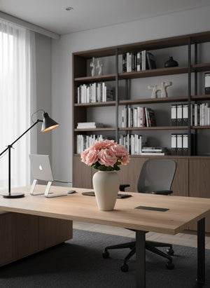 Soft pink faux rose arrangement in a ceramic vase styled on a modern home office desk #pink