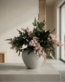 Real touch pale-pink coloured faux berry arrangement with green foliage on a table in a minimalistic room #pale-pink