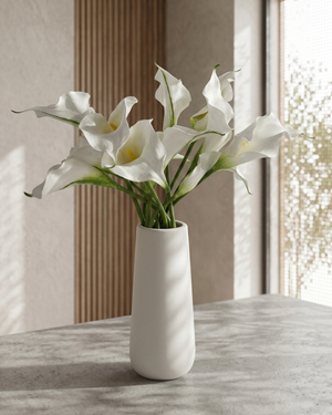 Real touch artificial white calla lily arrangement in a white ceramic vase on marble surface #white