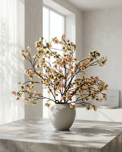 Lifelike faux blush pink cherry blossom branches in a white ceramic vase on a marble surface with a light background #blush-pink