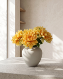 Real touch apricot orange faux dahlia arrangement in a matte ceramic vase on a concrete table #apricot-orange