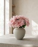 Real touch pink faux dahlia arrangement in a matte ceramic vase on concrete table with neutral background #pink