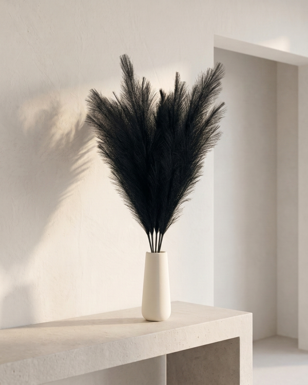 Black faux pampas grass bouquet in white ceramic vase on concrete table, luxury neutral boho home decor #black