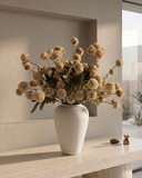 White vase with beige coloured real touch faux pompon flowers on a wooden surface in a modern interior setting #beige
