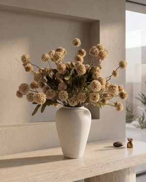 White vase with beige coloured real touch faux pompon flowers on a wooden surface in a modern interior setting #beige