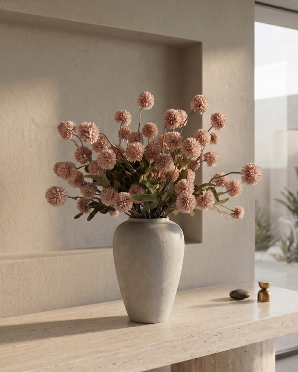 Decorative vase with pink coloured real touch faux pompon flowers on a wooden surface in a modern interior setting #light-pink