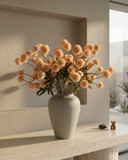 Bouquet of pale-peach coloured  real touch pompon flowers in a grey vase on a light wooden surface with a neutral background #pale-peach