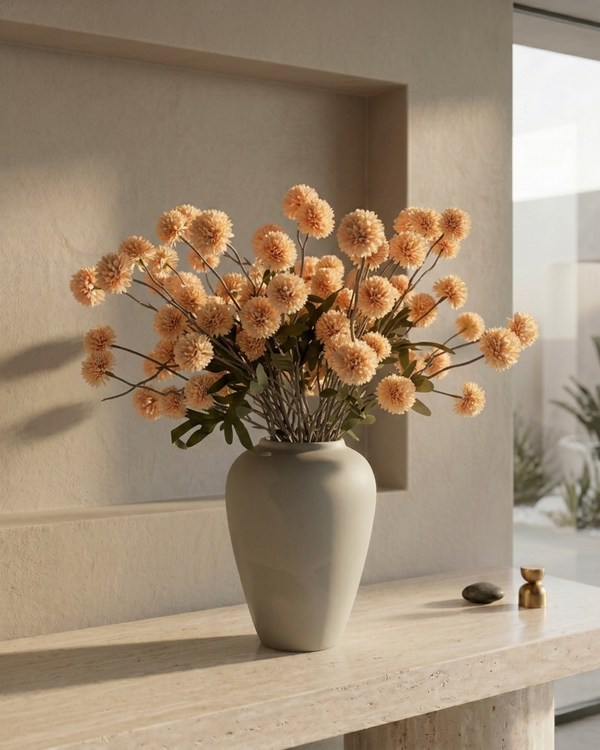 Bouquet of pale-peach coloured  real touch pompon flowers in a grey vase on a light wooden surface with a neutral background #pale-peach