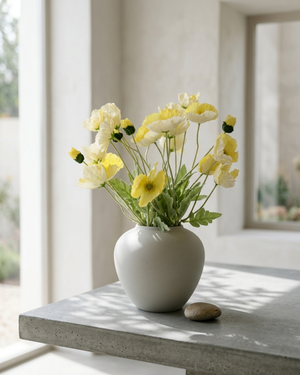 Real touch faux yellow poppy arrangement in a ceramic vase, styled on a concrete table for modern home décor #yellow