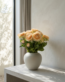 Realistic real touch peach coloured faux ranunculus arrangement in a matte ceramic vase styled on concrete table #soft-peach 