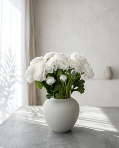 Realistic real touch white faux ranunculus arrangement in a matte ceramic vase styled on a concrete surface #white 