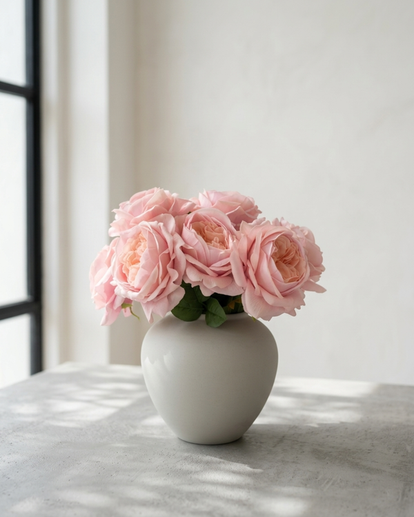 Real touch faux pink rose arrangement with soft layered blooms styled in a matte ceramic vase on a concrete surface #pink