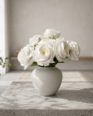 Real touch faux white rose arrangement with soft layered blooms styled in a matte ceramic vase on a concrete surface #white